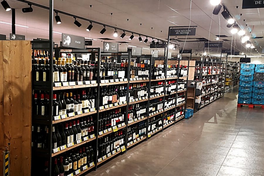 Track lighting installation reference — multiple track heads over retail shelving